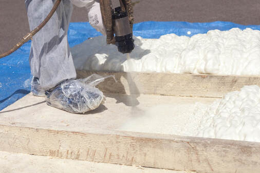 An image of a person working on a spray foam insulation service