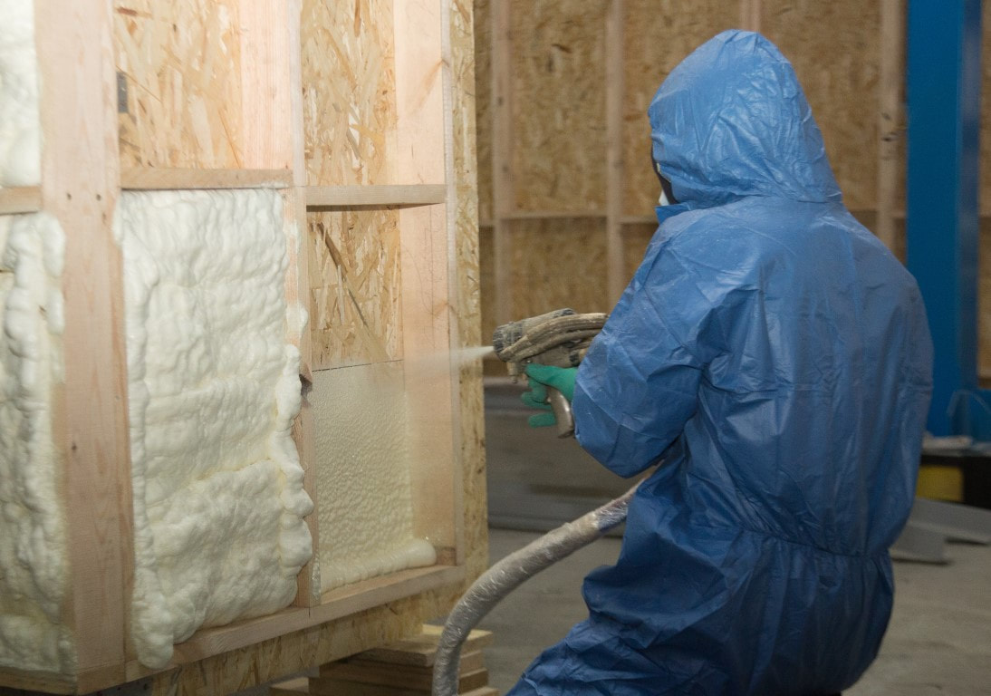 A picture of a person applying spray foam insulation